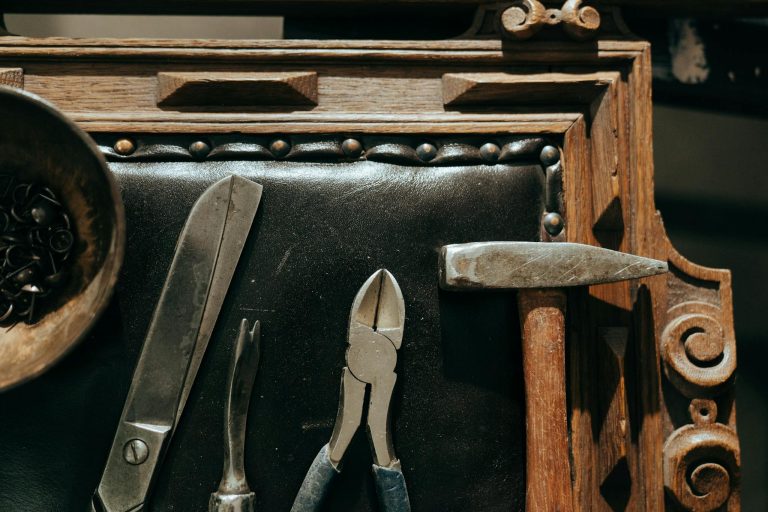 Top view of vintage tools on a wooden table, perfect for restoration and craft themes.