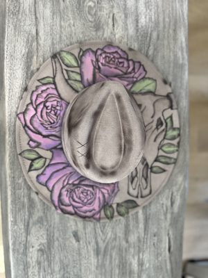 hand burned wide brim hat featuring cow skull with horns and hand painted pink and purple roses.