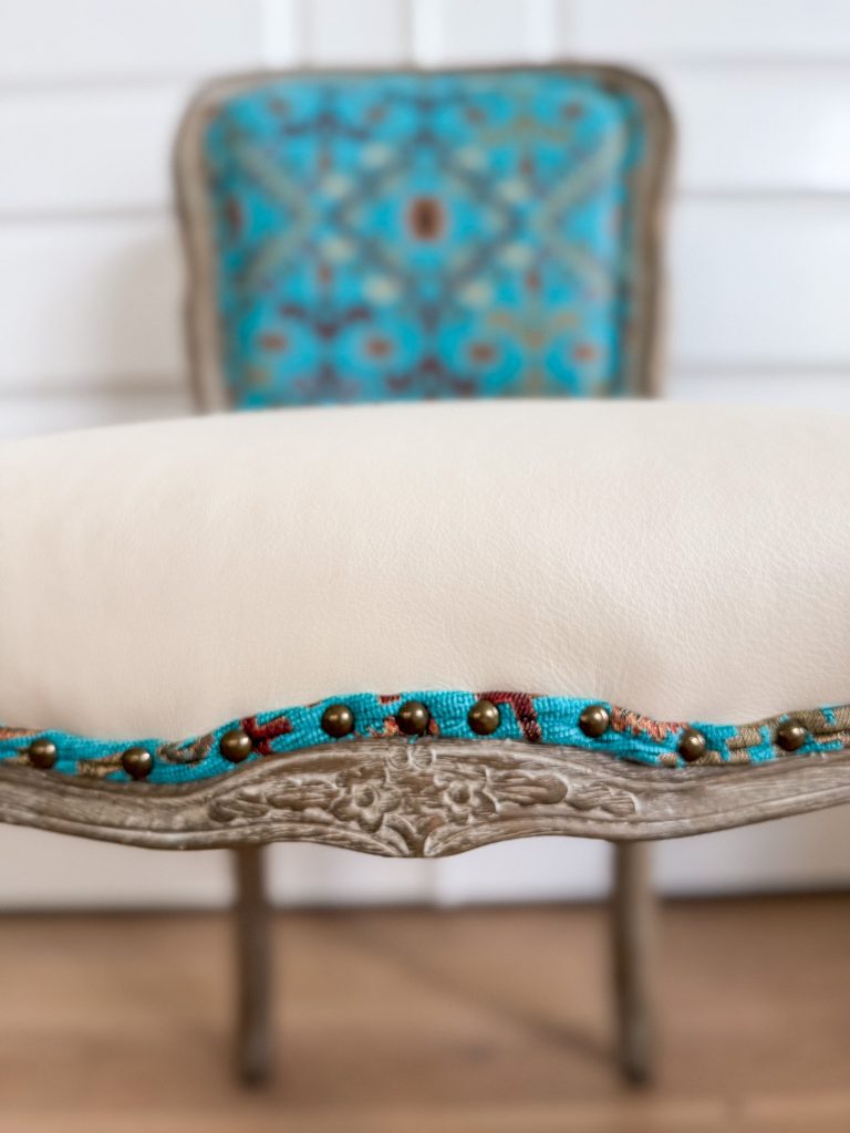 Southwestern style accent chair with cream leather seat and turquoise geometric textile back