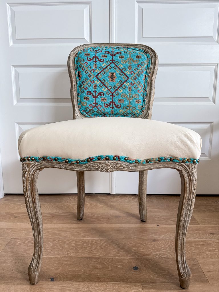 Southwestern style accent chair with cream leather seat and turquoise geometric textile back