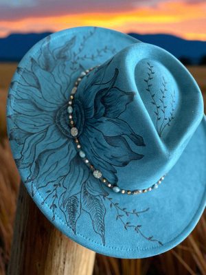 peacock blue wide brim hat with a hand burned design of a sunflower.